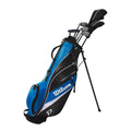 A Wilson 2025 Deep Red Junior Set (9-12 Years, Blue) golf bag holds several clubs and features a stand, multiple zippered compartments, and the Wilson name displayed on the side.
