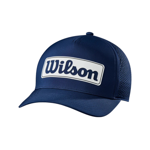 The Wilson 2025 Golf Performance Cap features a navy color, mesh back, and a white patch with bold blue Wilson lettering. This lightweight cap is designed for comfort and breathability on the golf course.