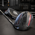 Used Wilson DYNAPWR 10.5 degree right-handed driver in dark workshop with matching headcover