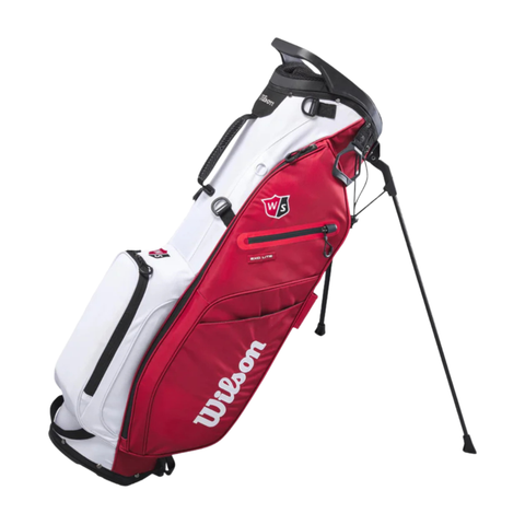 The Wilson Exo Lite Stand Bag in Black/Red/White features built-in foldable legs, multiple zippered pockets, and displays the Wilson logo on the side.
