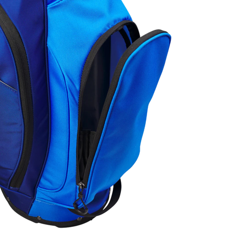 A close-up of the Wilson Exo Lite Stand Bag | Dark Blue/Light Blue by Wilson shows its lightweight design, 5-way top, and a partially open zippered pocket revealing the black interior against a white background.