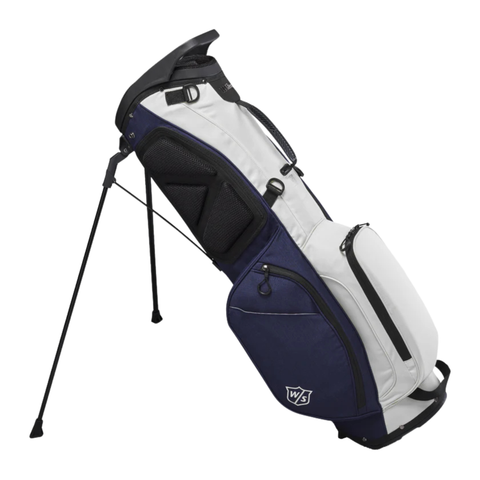 The Wilson Exo Lite Stand Bag in Navy/White by Wilson features multiple zippered pockets, a built-in stand, and the WS logo near the base. Lightweight and ideal for golfers on the go, shown here against a white background.