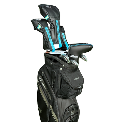 The Wilson Women's Dynapwr Golf Club Set features forgiving clubs with headcovers labeled DYNAPWR in black, blue, and white. The lightweight Wilson golf bag includes multiple zippered pockets and is shown isolated on a white background.