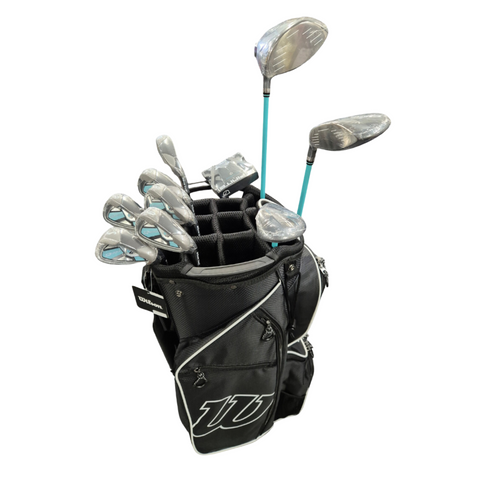 Wilson D300 Womens Golf Club Package set in a black golf bag with large white Wilson logo, featuring silver and teal clubs, top-front view.