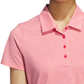 A person wears an Adidas Womens Ottoman Short Sleeve Polo Shirt, featuring thin pink and white stripes, a collar, and a four-button placket with red buttons; the persons head is partially out of frame.