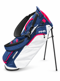 PING HooferLite 264 stand golf bag in Navy/White/Cherry, side view showing pockets and extended stand legs on a white background