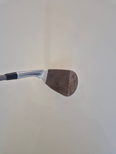 Raw face and grooves of the used Callaway Jaws Raw 56 degree wedge with visible surface rust