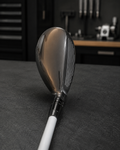Used left-handed Titleist 818 23 degree hybrid on the dark charcoal Golf 360 workshop bench