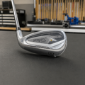 Unused right-handed Titleist T300 48 degree wedge in charcoal workshop setting